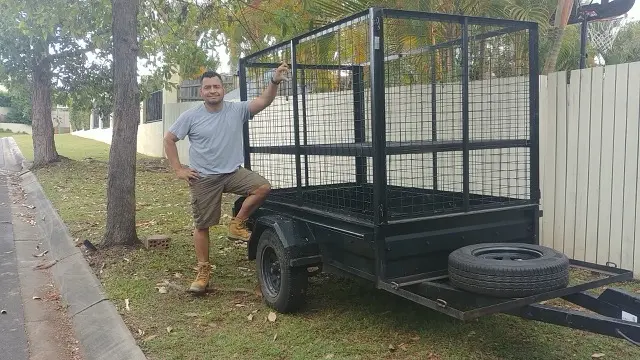 Owner standing next to their trailer that is making them beer money