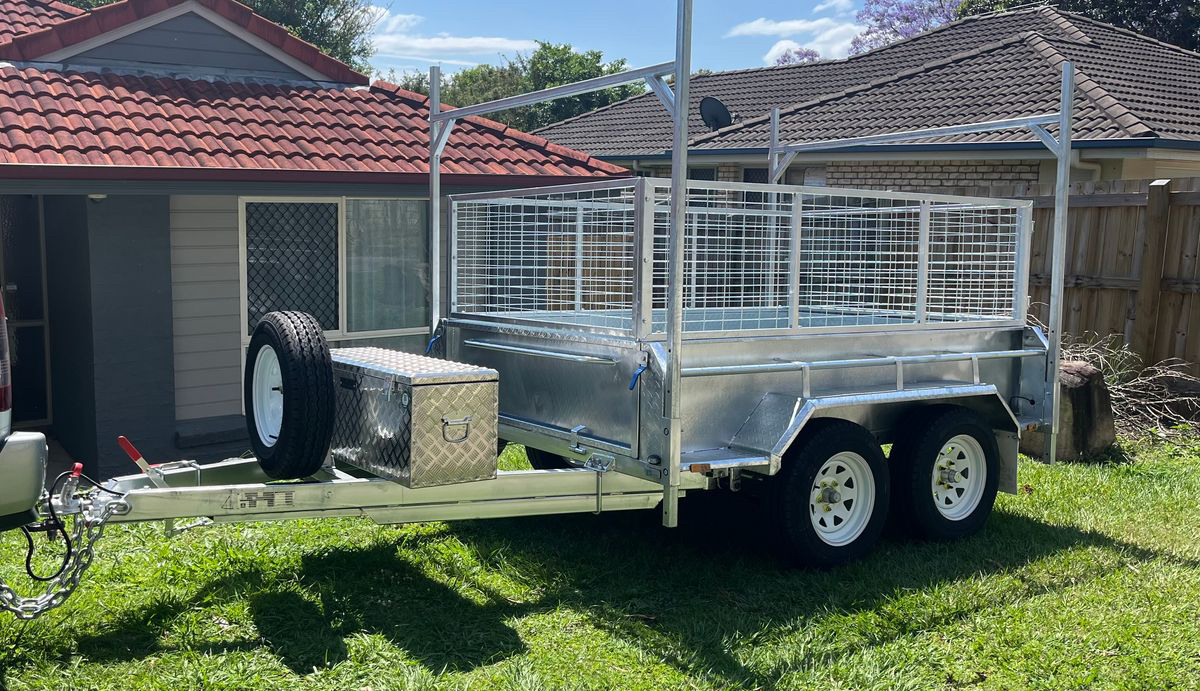 Medium 8x5 Cage Trailer for hire in Bellbird Park, with ladder racks, tool box and twin axle.