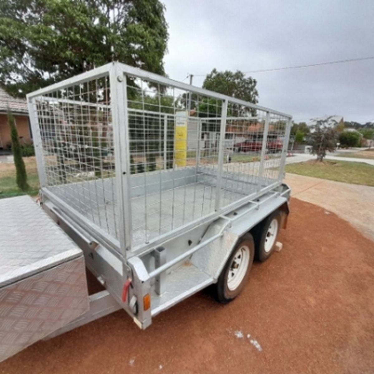 A 8x5 cage trailer with high side available for hire in Balga.